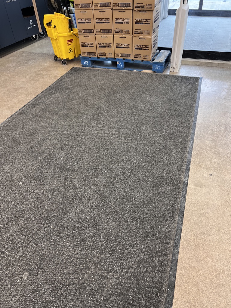 Dirty commercial entrance carpet before washing, full area view