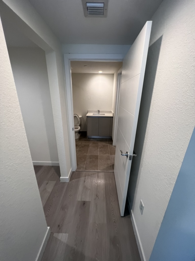 Clean apartment hallway and bathroom after final construction cleaning