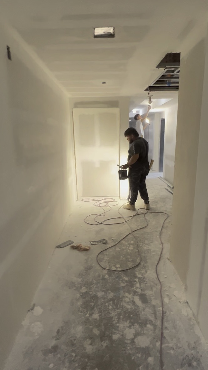 Dusty residential corridor during construction before detailed cleaning