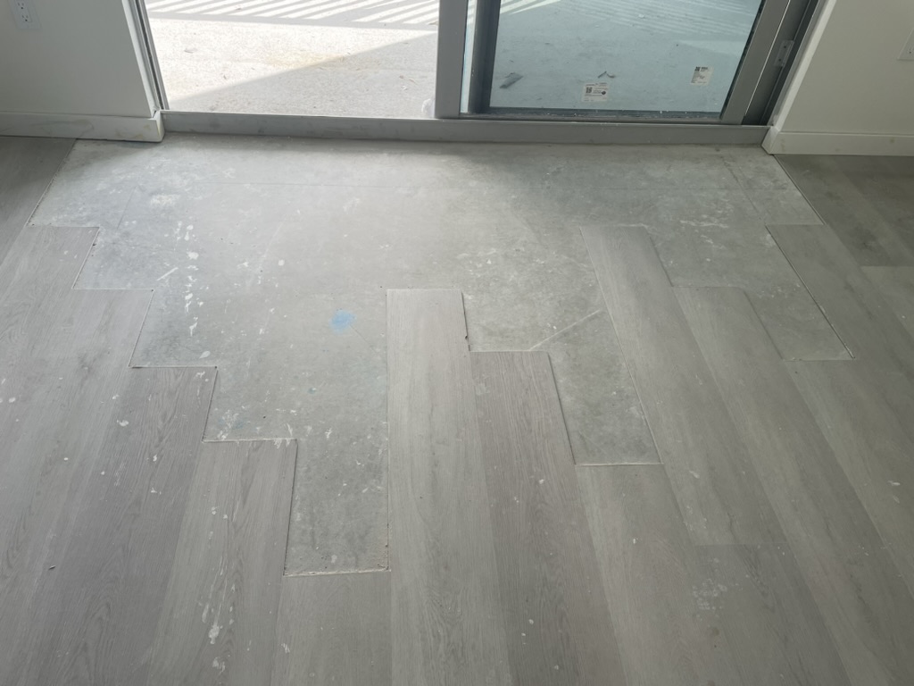 Construction dust and marks on newly installed apartment flooring